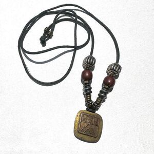 Baer SF sterling silver and brass pendant necklace on black cord